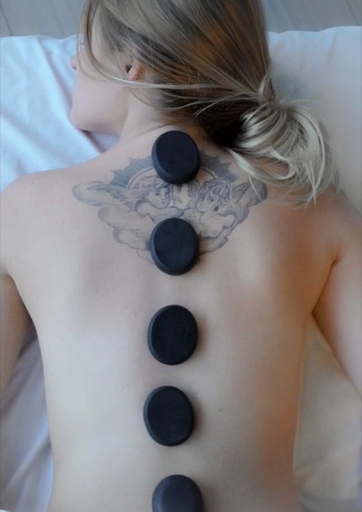 Hot stone therapy during a session
